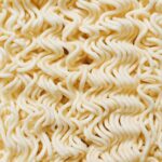 Detailed close-up of raw instant noodles showcasing their intricate texture and pattern.