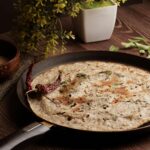 Crispy paratha in a skillet with spices makes a delightful meal.